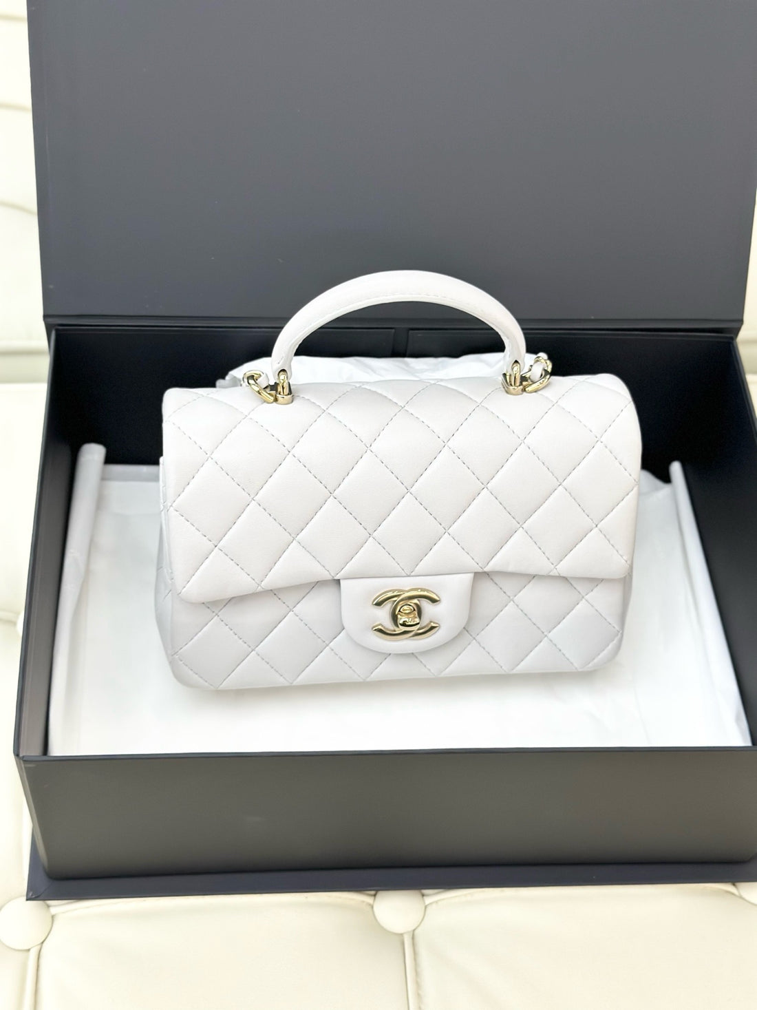 Chanel mini handbag, white pearlescent lambskin, gold hardware.