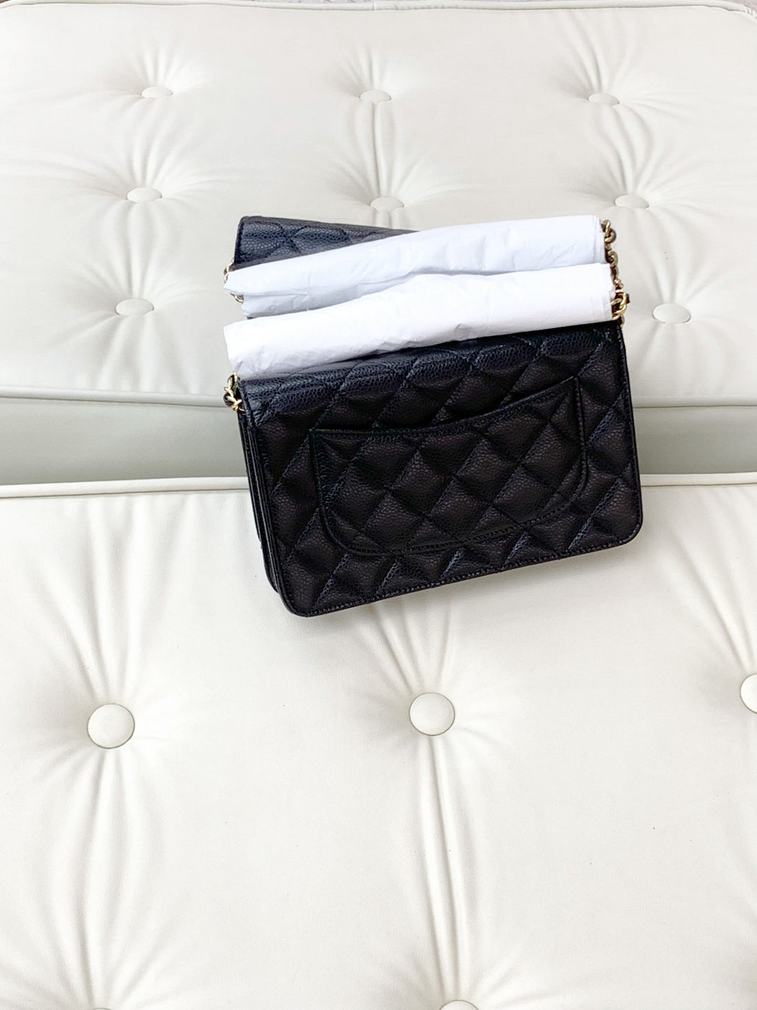 Chanel chain wallet with rotating clasp, caviar-textured leather, black.
