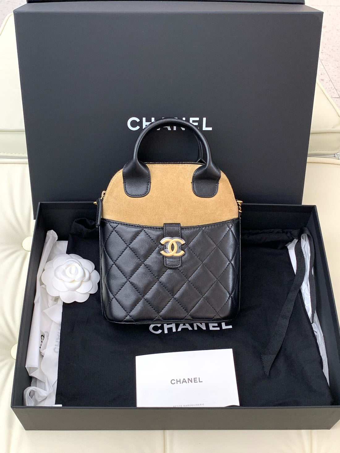 CHANEL black and beige suede and glossy lambskin quilted clutch with top handle and chain strap.