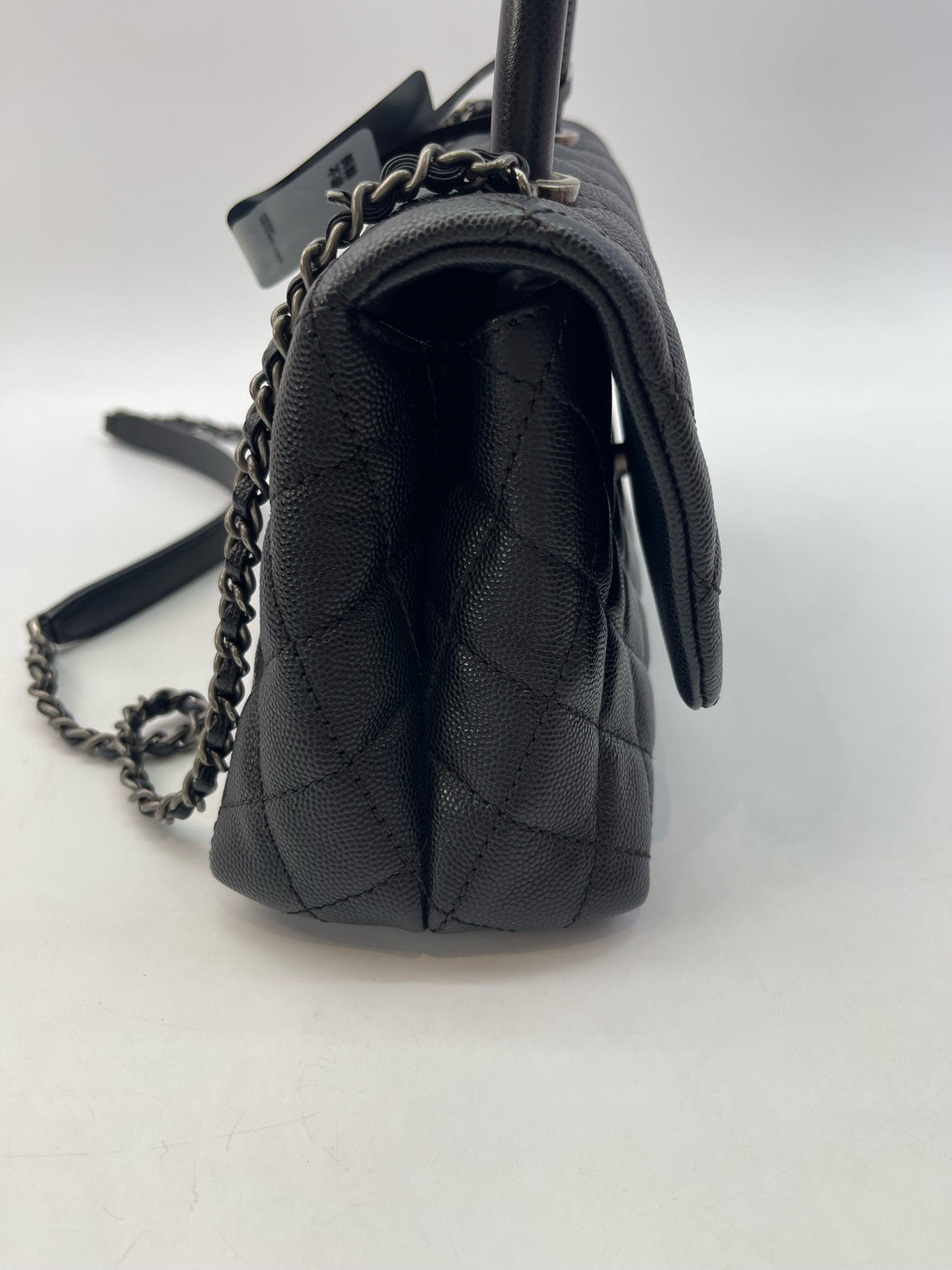 Chanel Coco Handle 24, made of pebbled leather with a lizard handle.